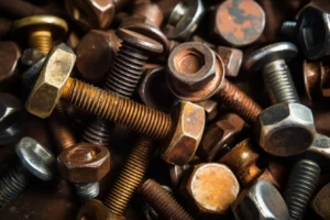 A pile of rusty screws including hex bolts and flat washers.