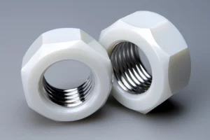 Two white plastic hex nuts on a grey background.
