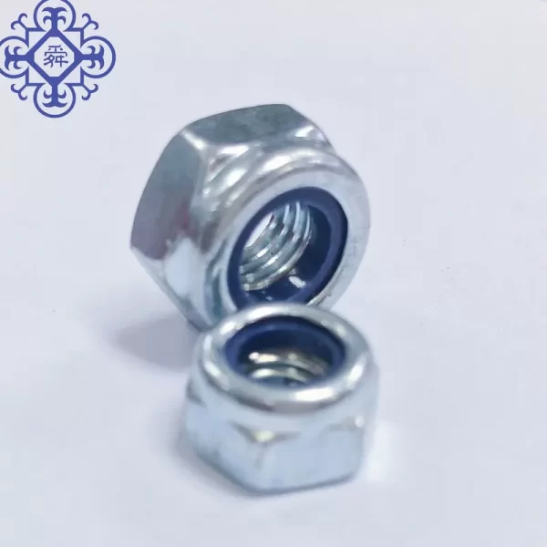 A close up of a 4.8mm White Zinc Plated Nylon Lock Nut DIN982.